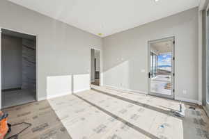 Spare room with baseboards and wood finished floors