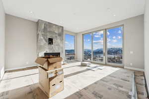 Living room with a tiled fireplace, recessed lighting, and baseboards