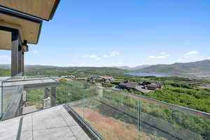 Balcony with a water and mountain view