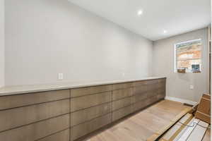 Interior space with recessed lighting, baseboards, and wood finished floors