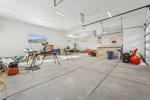 Garage with a workshop area and a garage door opener