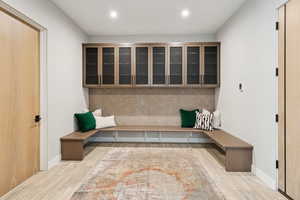 Mudroom with wood finished floors and recessed lighting