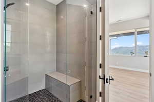 Bathroom featuring tiled shower, wood finished floors, and a mountain view