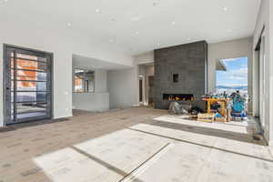 Unfurnished living room with recessed lighting, wood finished floors, and a fireplace