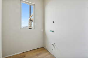 Laundry area featuring light hardwood / wood-style flooring