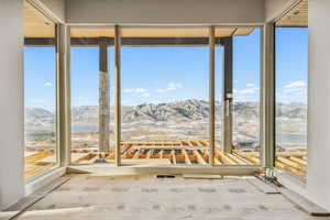 Unfurnished sunroom featuring a mountain view