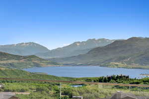 View of mountain backdrop featuring a nearby body of water