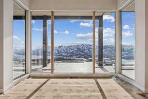 Unfurnished sunroom with a mountain view