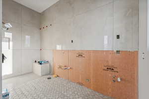 Bathroom with tile patterned flooring and tile walls