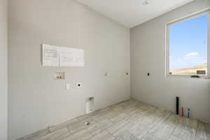 Laundry area featuring a wealth of natural light, hookup for a washing machine, and hookup for an electric dryer