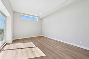 Spare room with wood finished floors and recessed lighting