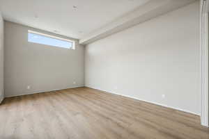 Empty room with light hardwood / wood-style flooring