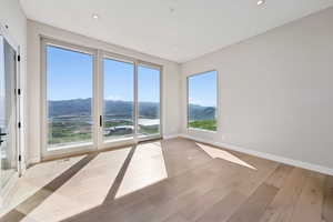 Spare room featuring a mountain view, wood finished floors, and recessed lighting