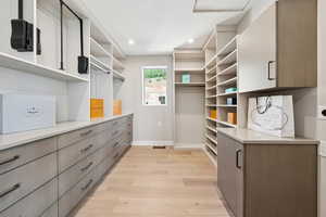 Walk in closet featuring light wood-style floors