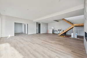 Unfurnished living room with light hardwood / wood-style floors