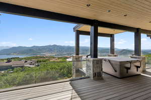 Deck with a water and mountain view