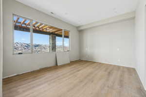 Unfurnished room with light hardwood / wood-style floors