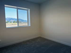 Empty room with a mountain view and carpet