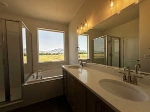 Bathroom with plus walk in shower, dual vanity, and a textured ceiling