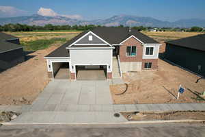 View of front of property featuring a mountain view and a garage