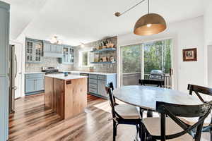 Kitchen with electric range, a wealth of natural light, and light wood-style LVT flooring