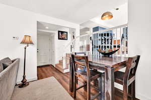 Dining area with dark hardwood / wood-style LVT floors