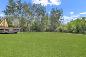 View of yard with a wooden deck