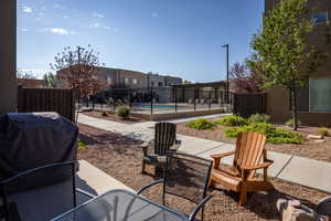 View of patio with grilling area and a fenced in pool