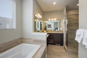 Bathroom featuring tile patterned floors, plus walk in shower, and vanity