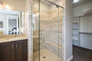 Bathroom featuring vanity and an enclosed shower