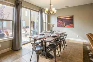 Dining area featuring an inviting chandelier and light tile patterned floors