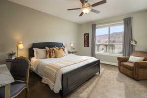 Carpeted bedroom featuring ceiling fan