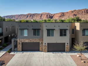 View of front facade with a mountain view and a garage