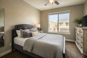 Bedroom with multiple windows, carpet, and ceiling fan