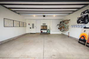 Garage with electric panel and a garage door opener