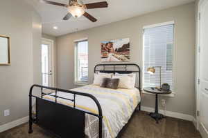 Bedroom with ceiling fan and dark carpet