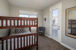 Carpeted bedroom featuring access to exterior and multiple windows