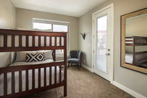 Carpeted bedroom featuring access to exterior