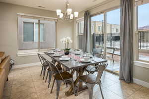 Tiled dining area with an inviting chandelier