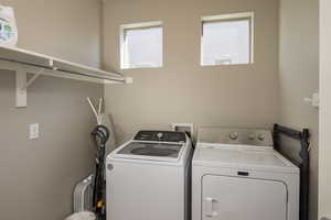 Laundry area with washing machine and clothes dryer