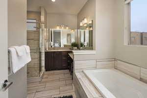 Bathroom with vanity, plus walk in shower, and tile patterned flooring