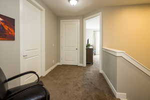 Hallway featuring carpet flooring