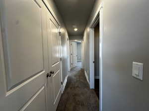 Hallway with dark carpet