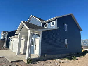 View of home's exterior with a mountain view and a garage