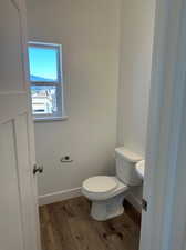 Bathroom with toilet and hardwood / wood-style floors