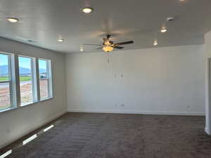 Spare room with carpet floors, a textured ceiling, and ceiling fan