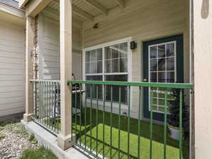 Property entrance featuring a porch and a yard