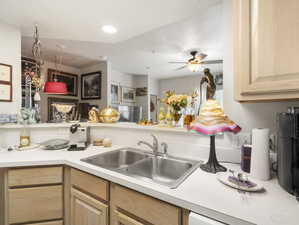 Kitchen featuring sink, light brown cabinetry, and ceiling fan