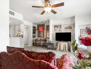 Living room featuring ceiling fan and light colored carpet