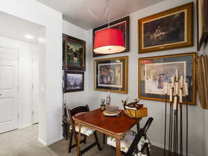 Dining area featuring light carpet